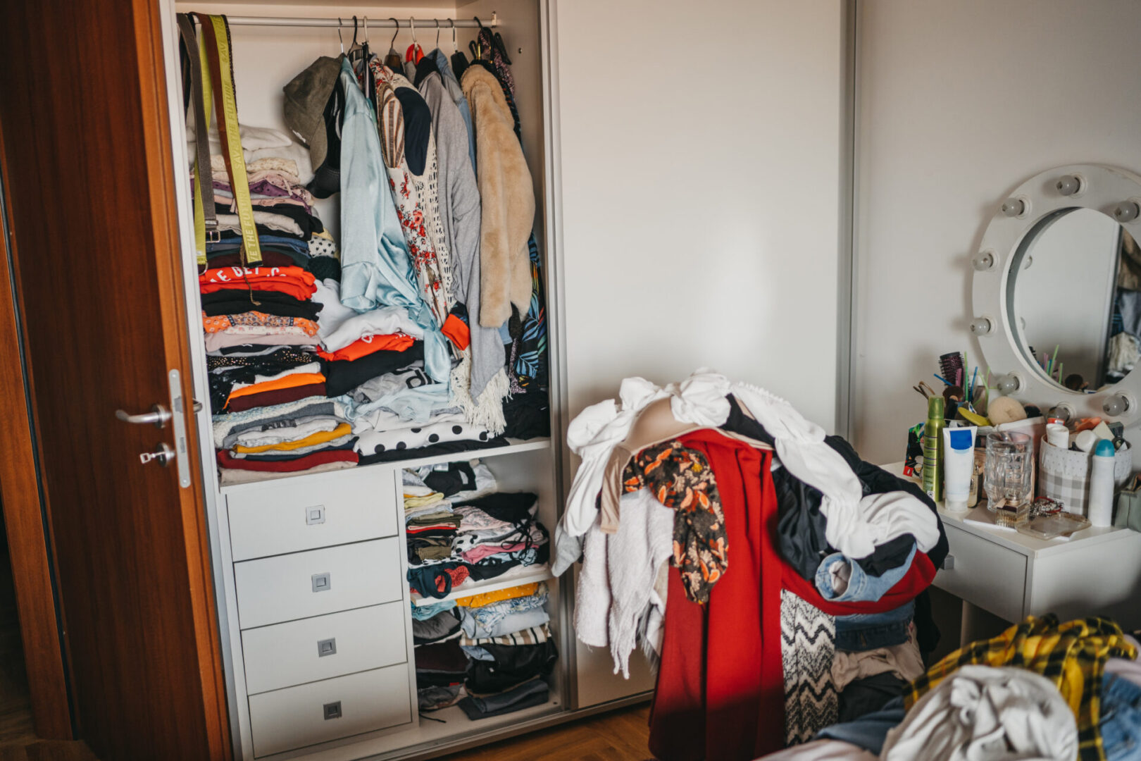 Wardrobe Full Of Clothes and dressing table full of toiletries